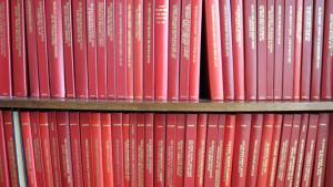 A collection of red books on a shelf